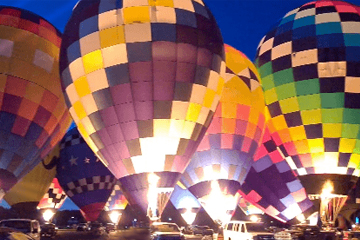 Your mental well-being and growth - Hot air ballons fully inflated lighted up at night