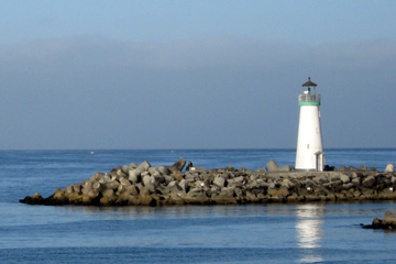 Our Knowledge - Lighthouse on Rocks on Ocean Coastline