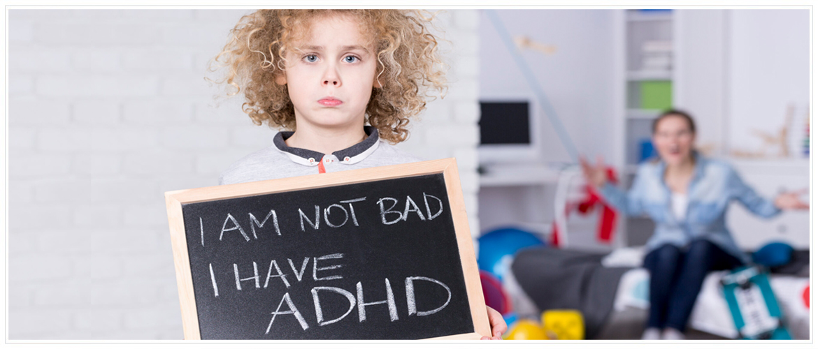 Attention-Deficit / Hyperactivity Disorder (ADHD) - Hero Image - Boy holding small chalk board saying I'm not bad