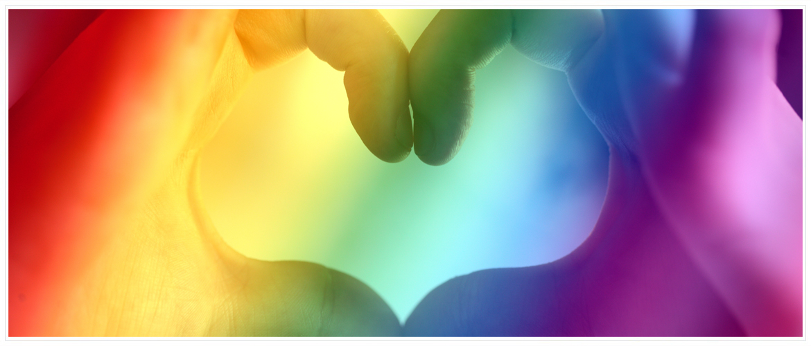 Contact Us - Hero Image - Hands in shape of heart with rainbow lighting.